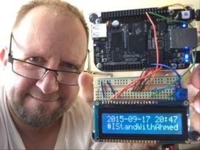 Photo of a man with a homemade clock showing a digital readout saying "2015-09-17 20:47 #IStandWithAhmed"